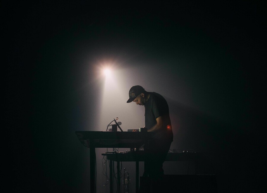 Indistinct voices over PA